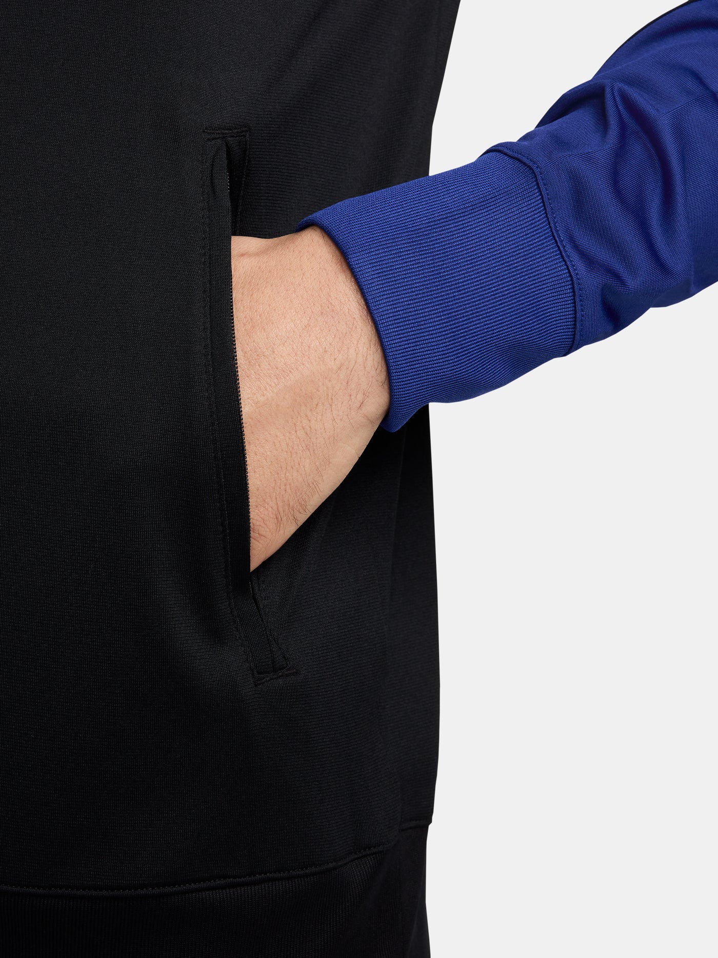 Black FC Barcelona tracksuit with red and blue sleeve cuffs, Nike logo and club crest.