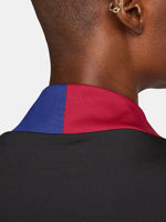 FC Barcelona black long-sleeve training top with white crest, Spotify logo, and red-blue shoulder accents.