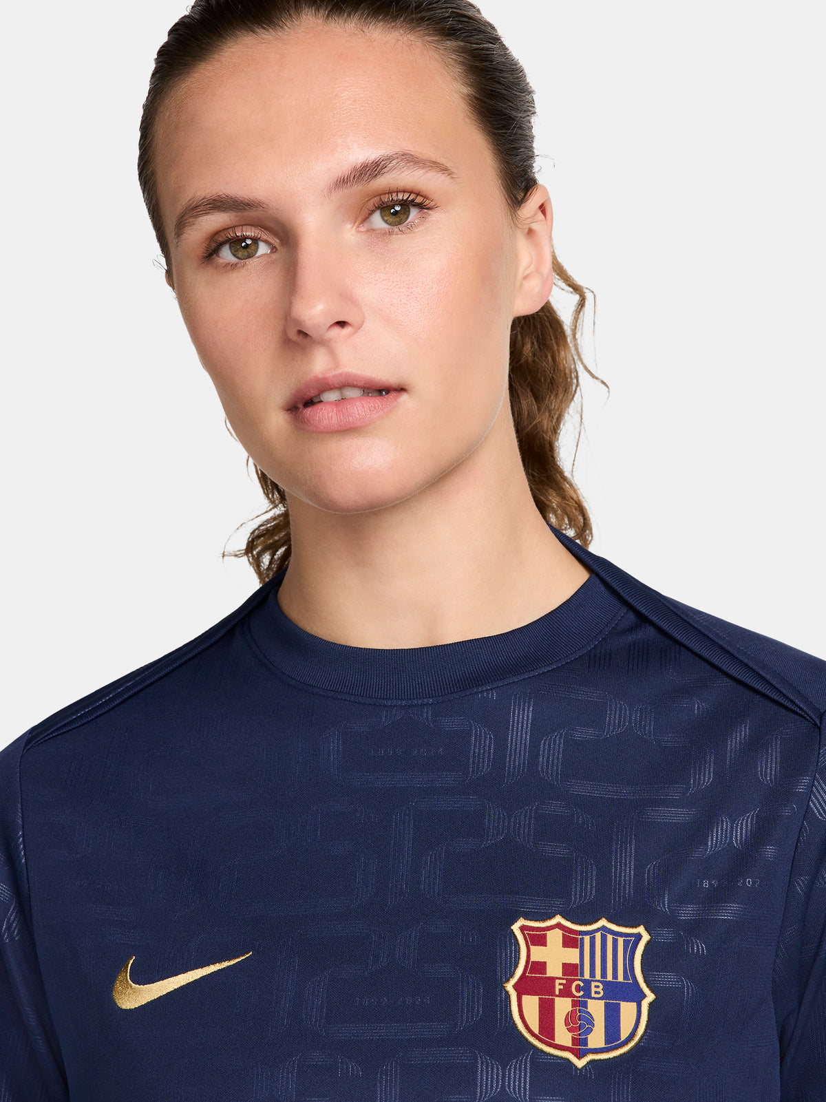 FC Barcelona warm-up shirt featuring a black base with a striking vertical stripe pattern in alternating red and blue. The shirt displays the red Spotify logo in the center, along with the Nike swoosh and FC Barcelona crest, also in red.