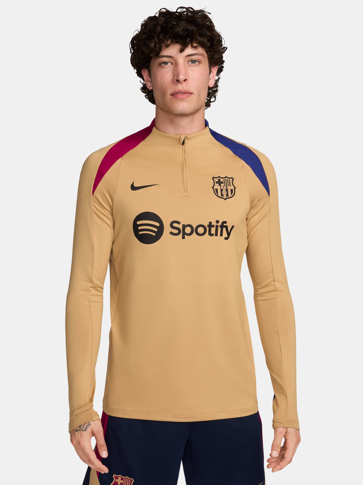FC Barcelona long-sleeve training top in gold with red and blue shoulder accents, featuring the Nike logo and Spotify sponsor on the chest.