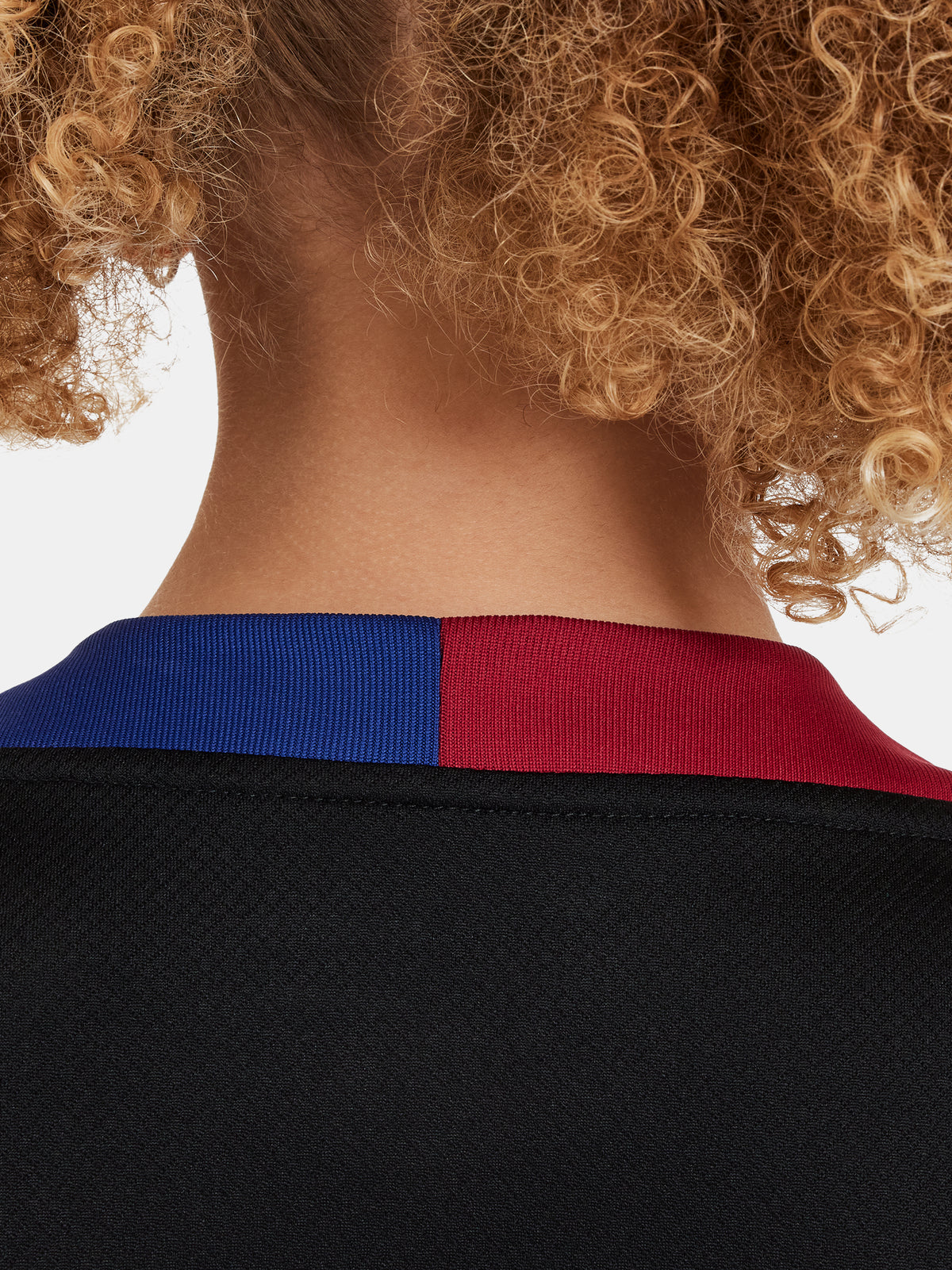 FC Barcelona black kids' training shirt with white Spotify logo and crest, red and blue shoulder details.
