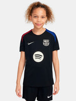 FC Barcelona black kids' training shirt with white Spotify logo and crest, red and blue shoulder details.