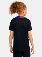 FC Barcelona black kids' training shirt with white Spotify logo and crest, red and blue shoulder details.