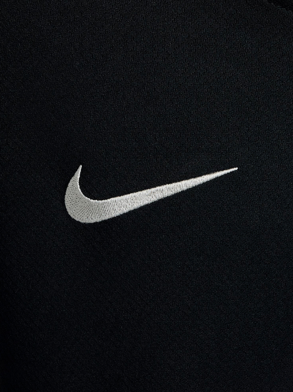 FC Barcelona black kids' training shirt with white Spotify logo and crest, red and blue shoulder details.