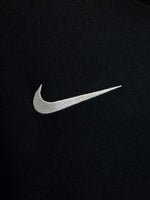 FC Barcelona black kids' training shirt with white Spotify logo and crest, red and blue shoulder details.