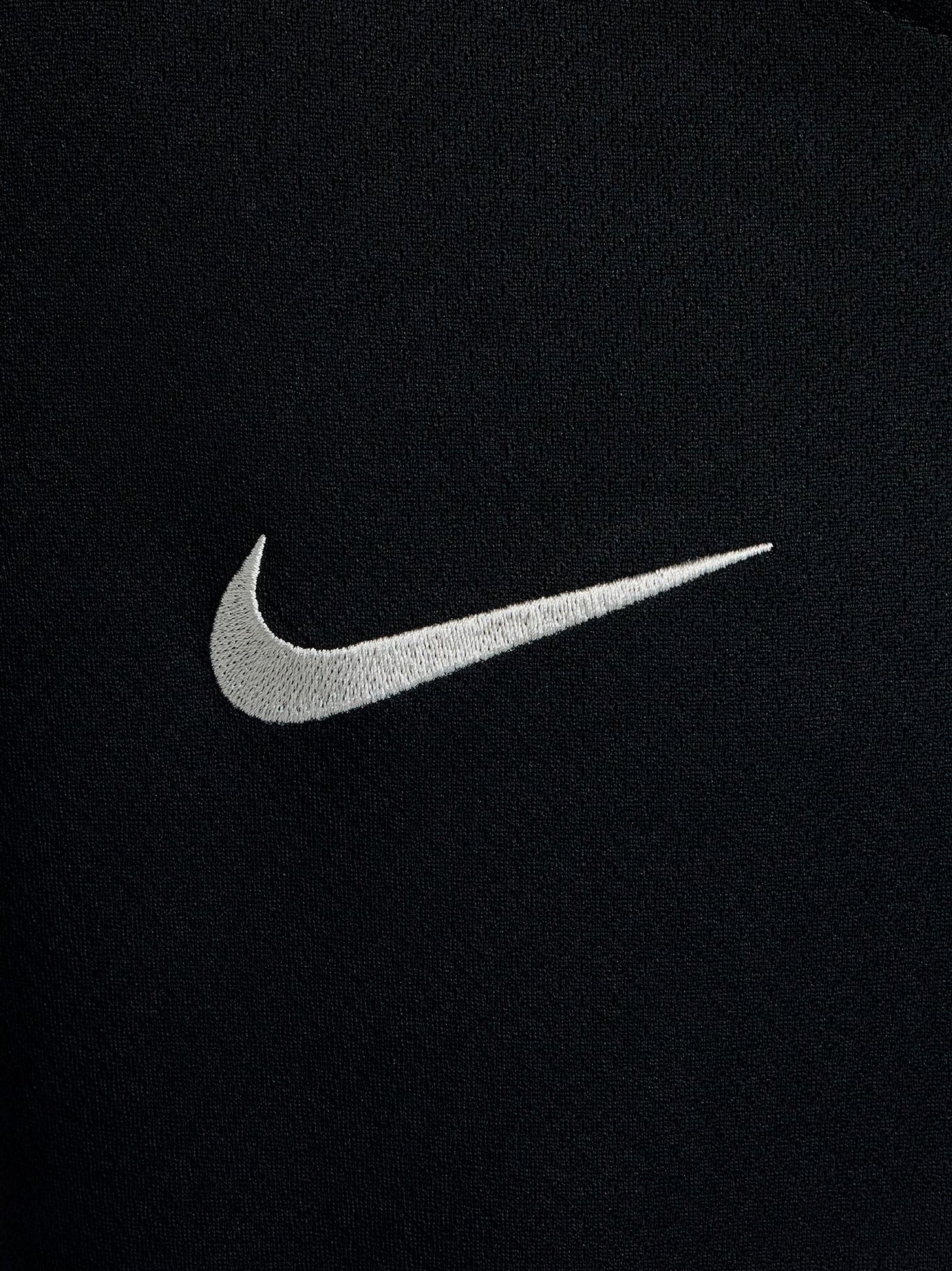 FC Barcelona black kids' training shirt with white Spotify logo and crest, red and blue shoulder details.