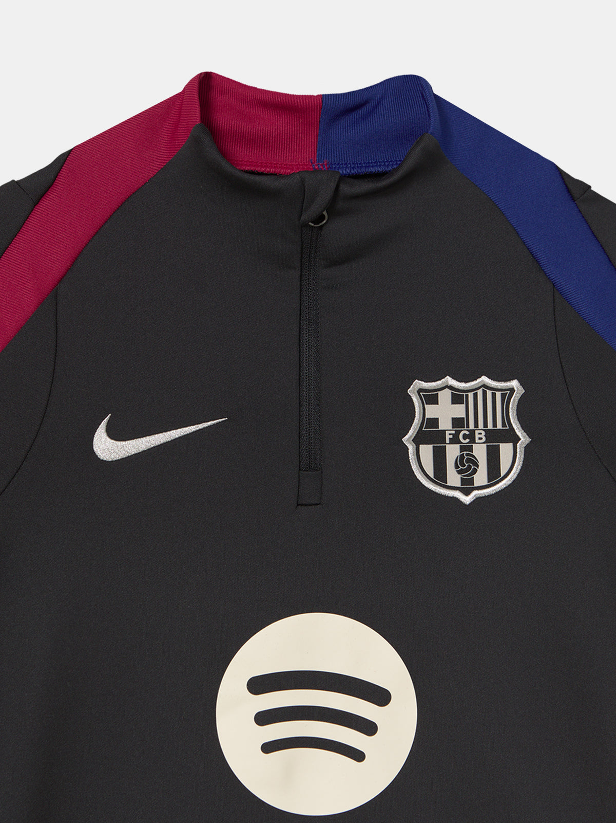 FC Barcelona black long-sleeve youth training top with white crest and central Spotify logo, red and blue shoulder panels.