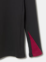 FC Barcelona black long-sleeve youth training top with white crest and central Spotify logo, red and blue shoulder panels.