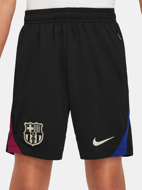 FC Barcelona kids' black shorts with white crest, Nike logo, and red-blue side accents.
