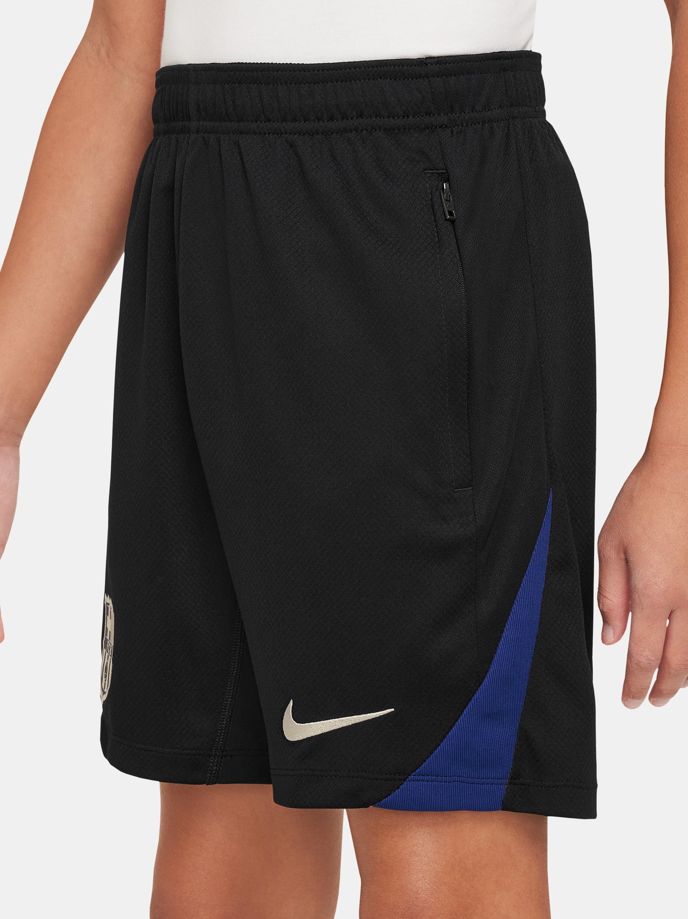 FC Barcelona kids' black shorts with white crest, Nike logo, and red-blue side accents.
