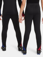 Black FC Barcelona training pants with beige crest and Nike logo.