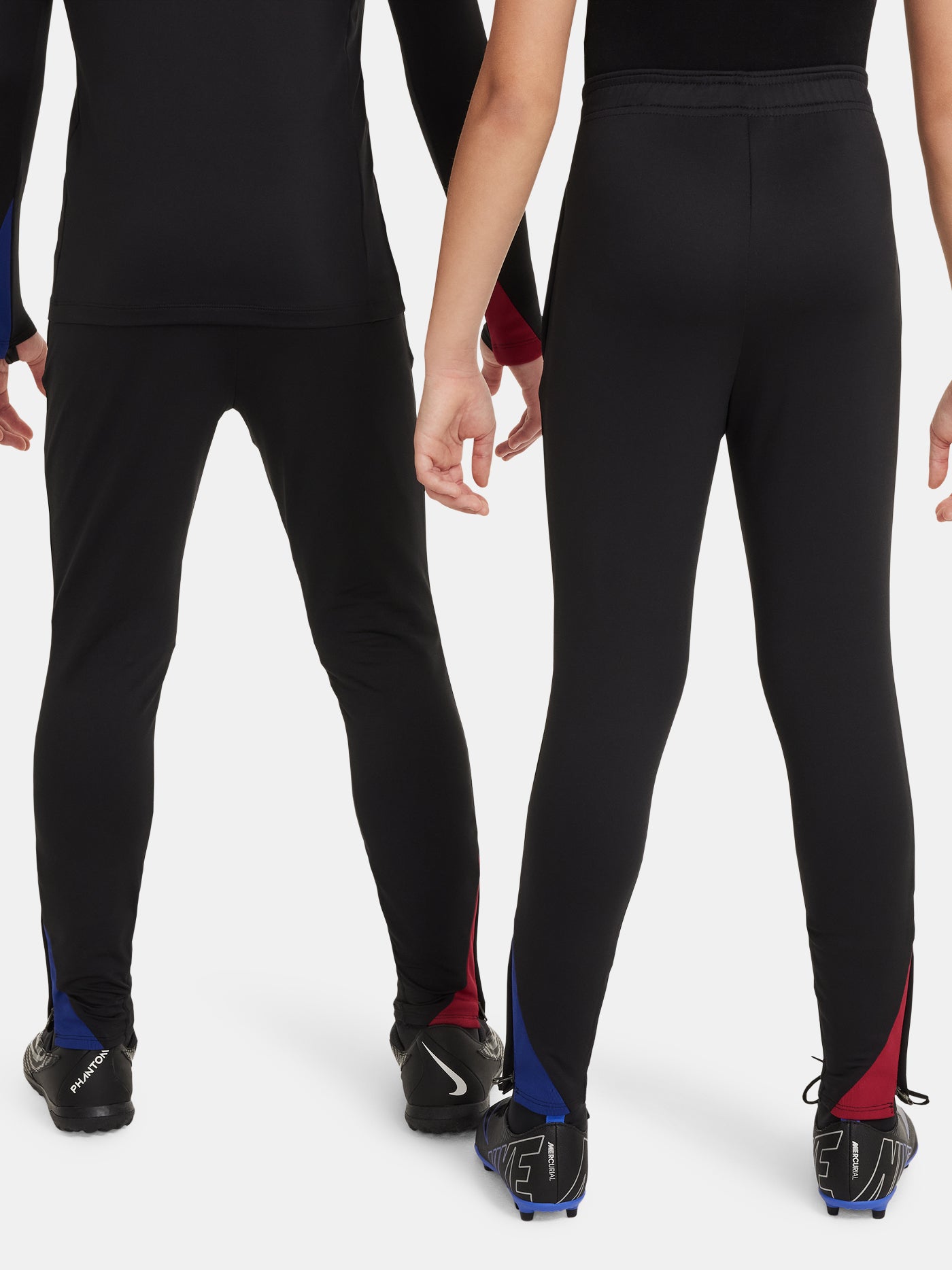Black FC Barcelona training pants with beige crest and Nike logo.