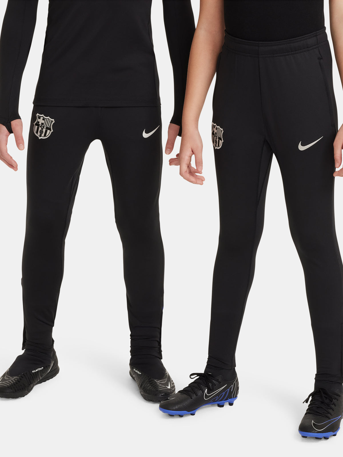 Black FC Barcelona training pants with beige crest and Nike logo.