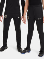 Black FC Barcelona training pants with beige crest and Nike logo.