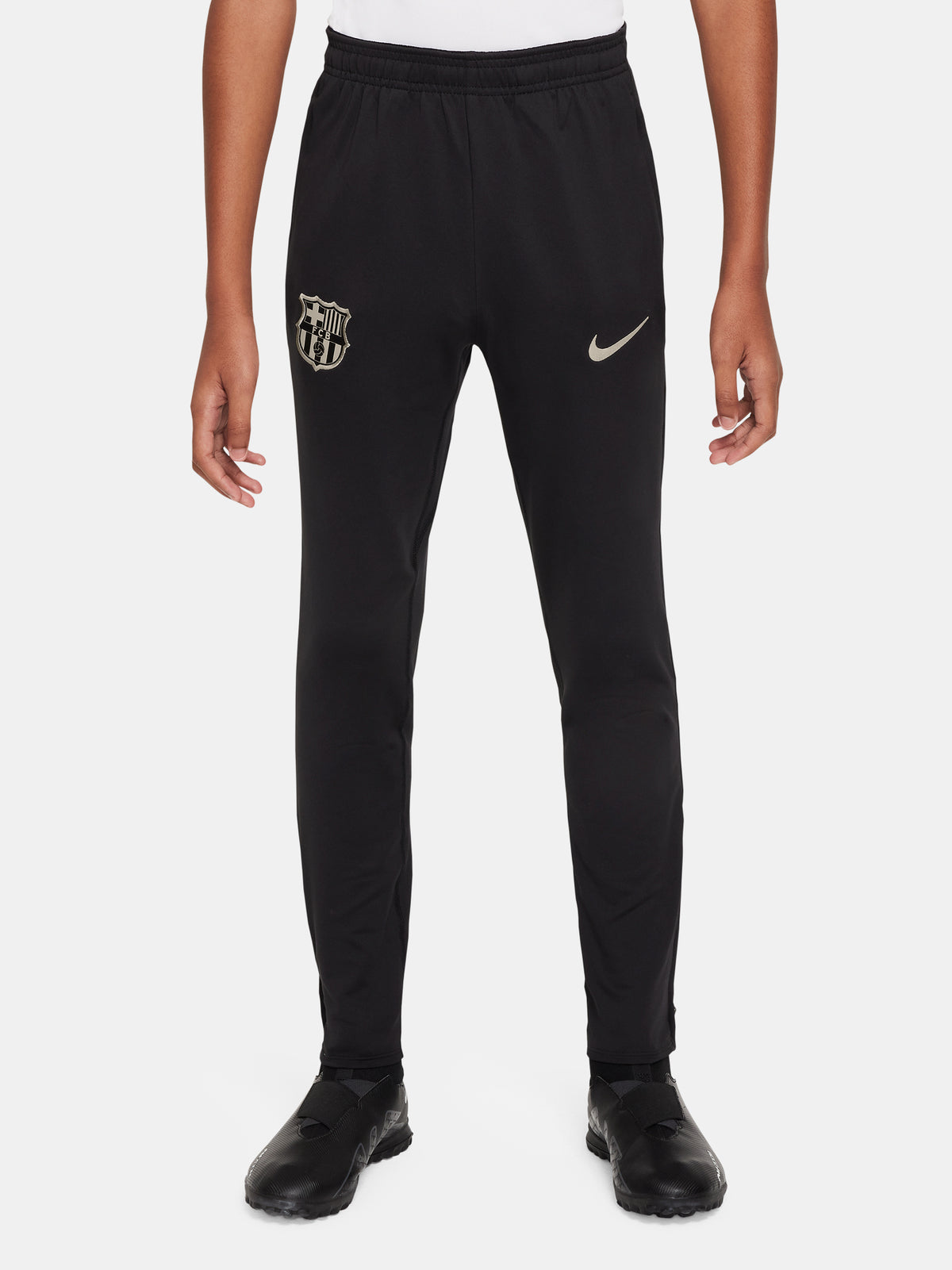 Black FC Barcelona training pants with beige crest and Nike logo.