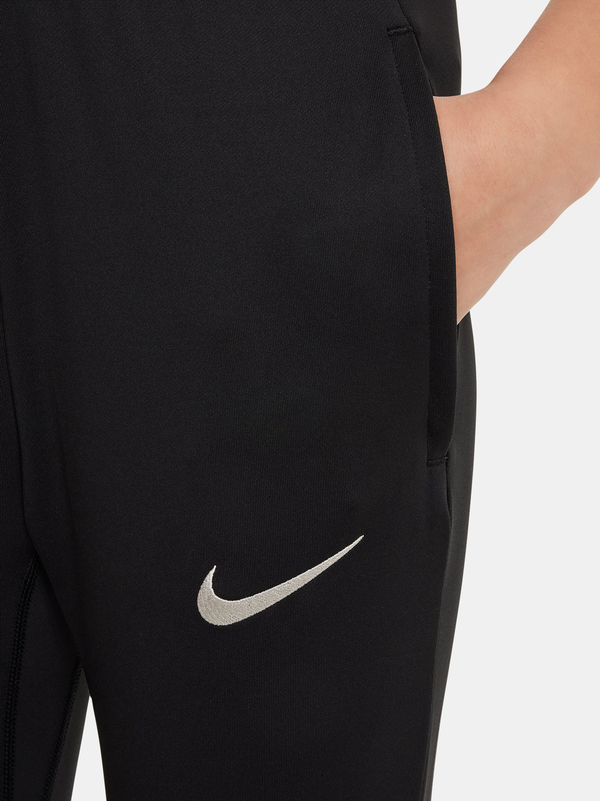 Black FC Barcelona training pants with beige crest and Nike logo.
