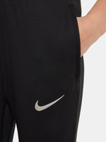 Black FC Barcelona training pants with beige crest and Nike logo.