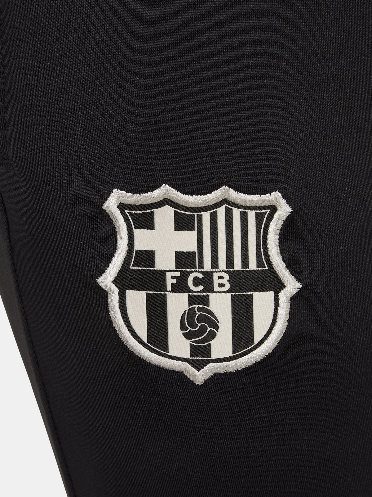 Black FC Barcelona training pants with beige crest and Nike logo.