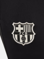 Black FC Barcelona training pants with beige crest and Nike logo.