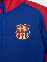 FC Barcelona retro-style jacket in blue and red with gold Nike logo and crest.
