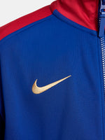 FC Barcelona retro-style jacket in blue and red with gold Nike logo and crest.
