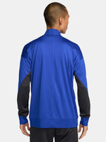 FC Barcelona blue full-zip training jacket featuring neon green Nike logo on the right chest and the FC Barcelona crest with Spotify sponsor on the left chest. Black accents on the lower sleeves. Paired with black training pants.