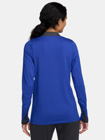 Women's FC Barcelona long-sleeve training top in vibrant royal blue with black shoulder accents, featuring light green Nike, Spotify, and club logos on the chest.