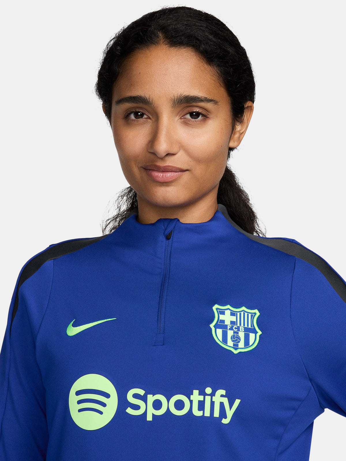 Women's FC Barcelona long-sleeve training top in vibrant royal blue with black shoulder accents, featuring light green Nike, Spotify, and club logos on the chest.