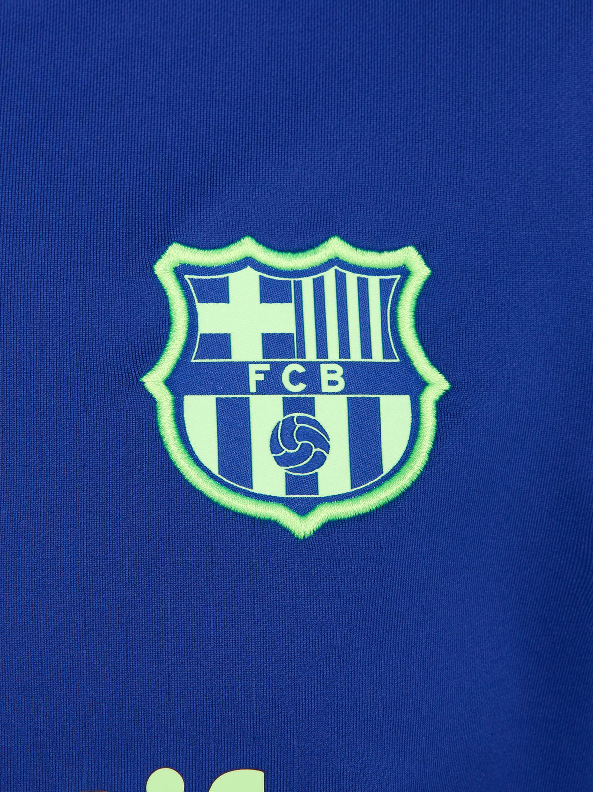 Women's FC Barcelona long-sleeve training top in vibrant royal blue with black shoulder accents, featuring light green Nike, Spotify, and club logos on the chest.