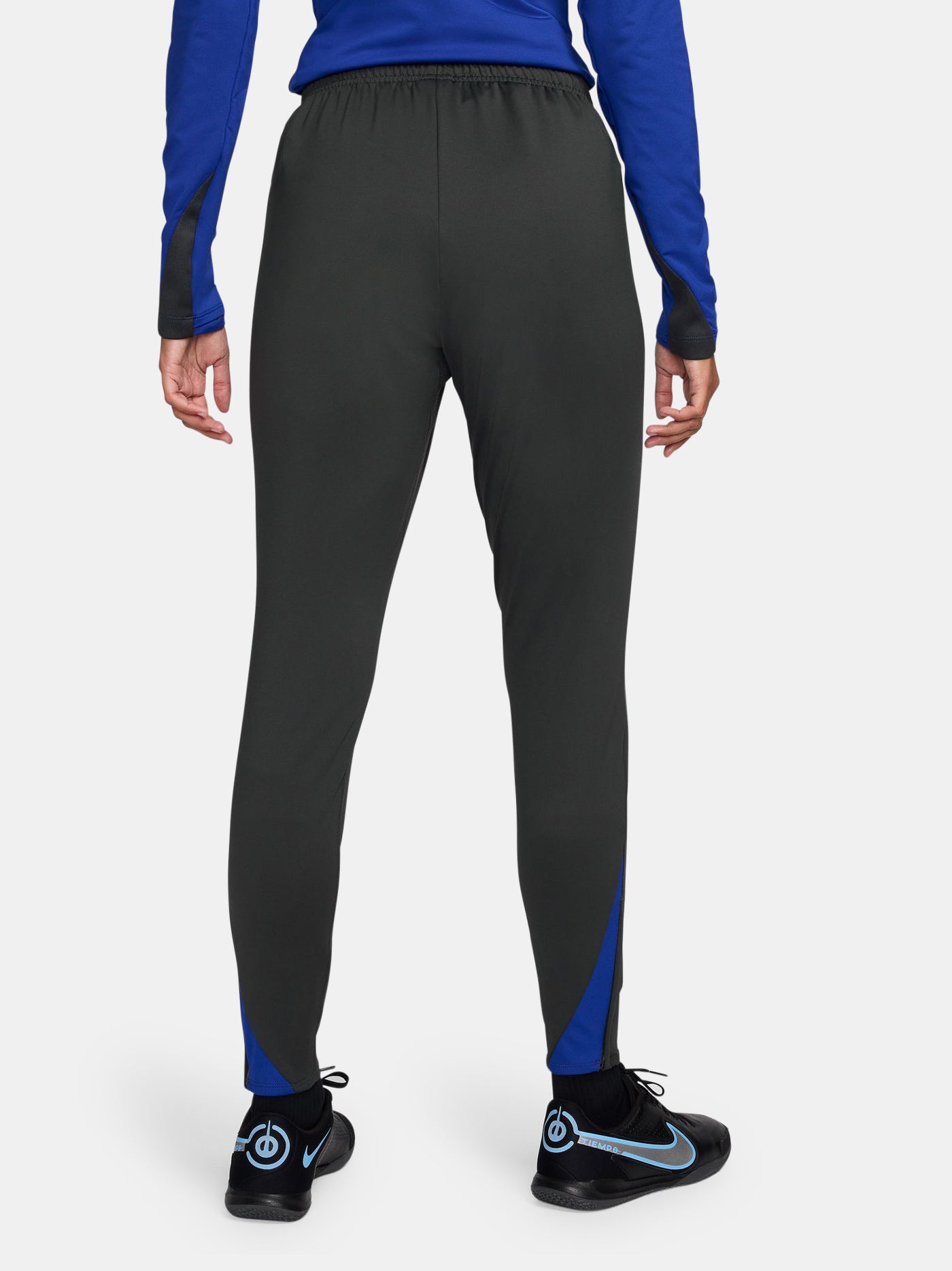 Black FC Barcelona track pants with neon green Nike logo and club crest.