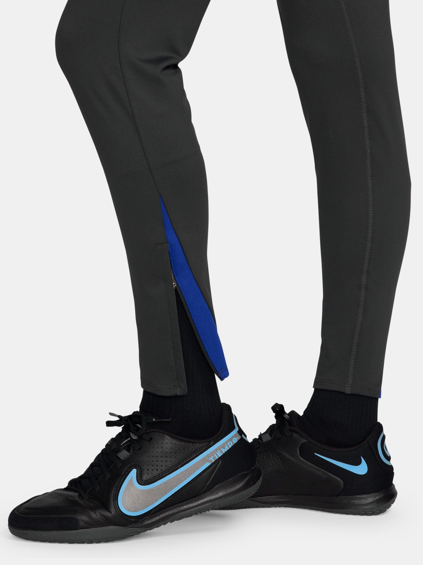Black FC Barcelona track pants with neon green Nike logo and club crest.