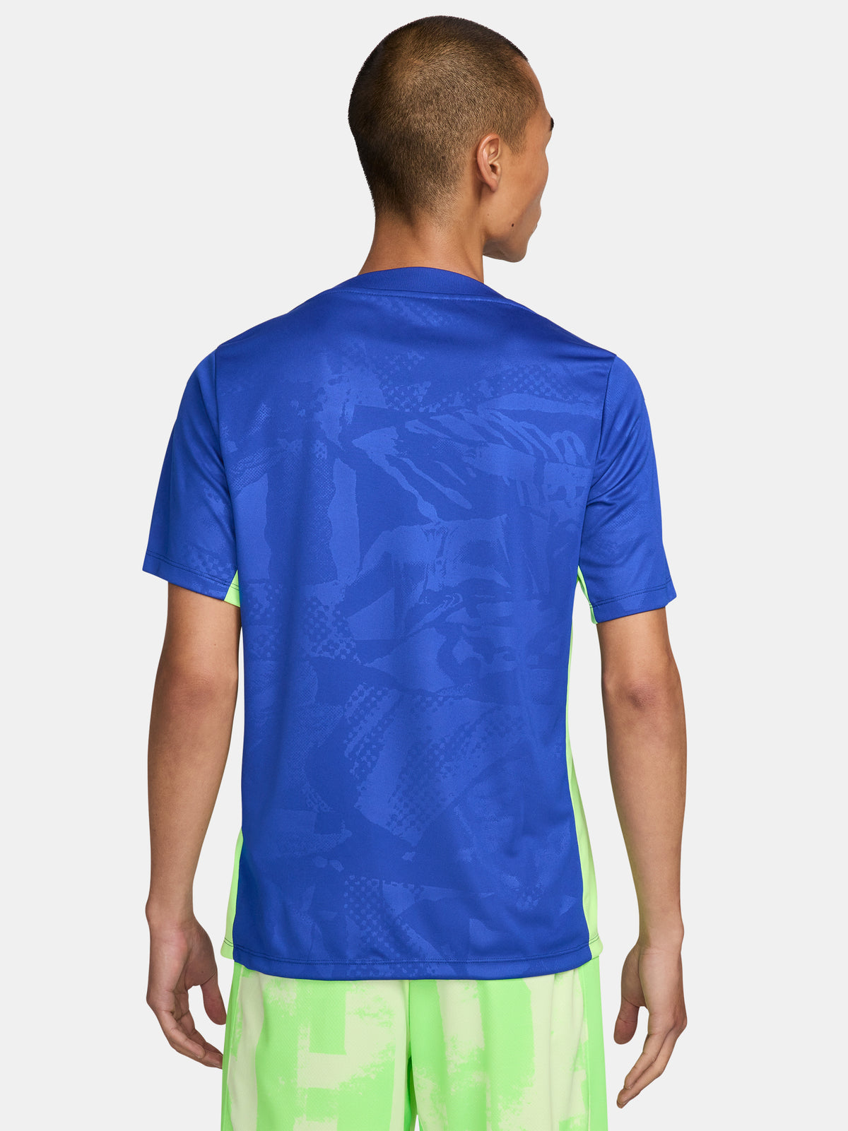 Blue and neon green FC Barcelona training jersey with Spotify and Nike logos.