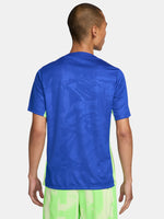 Blue and neon green FC Barcelona training jersey with Spotify and Nike logos.