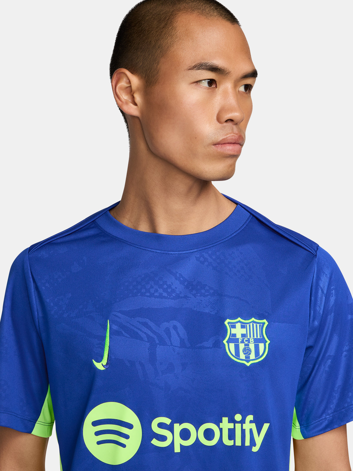 Blue and neon green FC Barcelona training jersey with Spotify and Nike logos.
