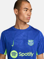 Blue and neon green FC Barcelona training jersey with Spotify and Nike logos.