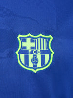 Blue and neon green FC Barcelona training jersey with Spotify and Nike logos.