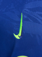 Blue and neon green FC Barcelona training jersey with Spotify and Nike logos.