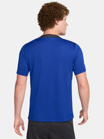 FC Barcelona training shirt in bright royal blue with black shoulder panels. The shirt features neon green logos: a Nike swoosh on the right chest, the FC Barcelona crest on the left chest, and the Spotify sponsor logo prominently across the center.