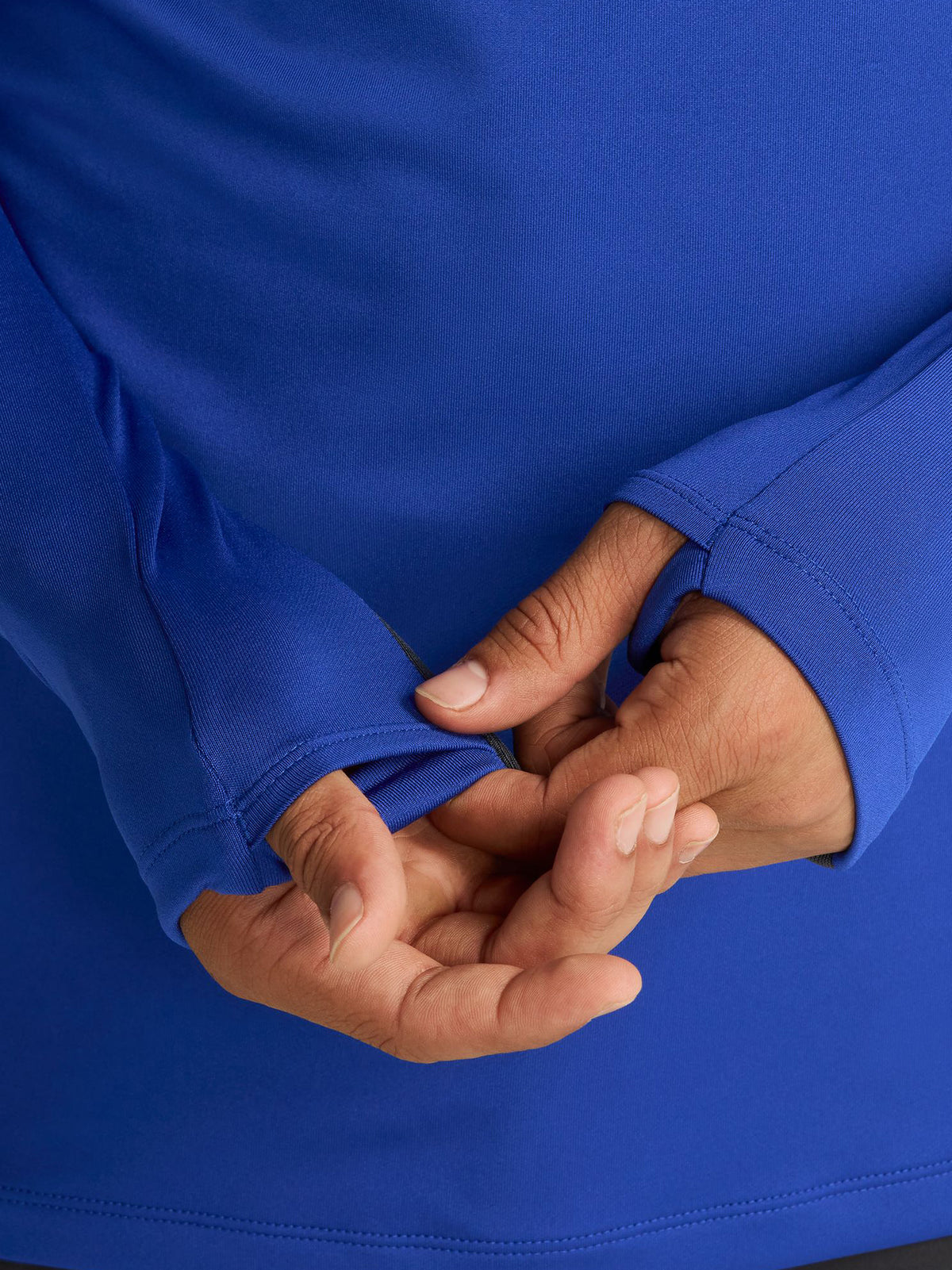 Men's FC Barcelona training kit consisting of a blue long-sleeve top with neon green Nike, Spotify, and club logos, paired with black training pants featuring matching neon green branding.
