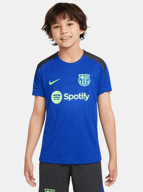 Blue FC Barcelona training jersey with neon green logos and black shoulder panels.