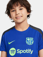 Blue FC Barcelona training jersey with neon green logos and black shoulder panels.