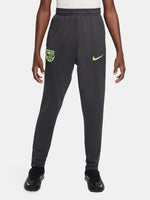 Black FC Barcelona training pants with neon green crest and Nike logo.