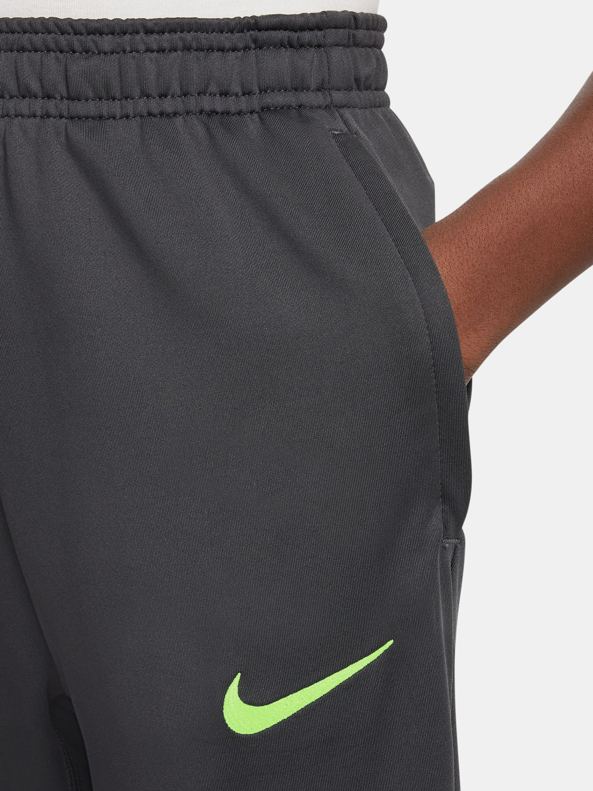 Black FC Barcelona training pants with neon green crest and Nike logo.