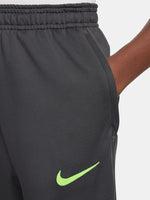 Black FC Barcelona training pants with neon green crest and Nike logo.