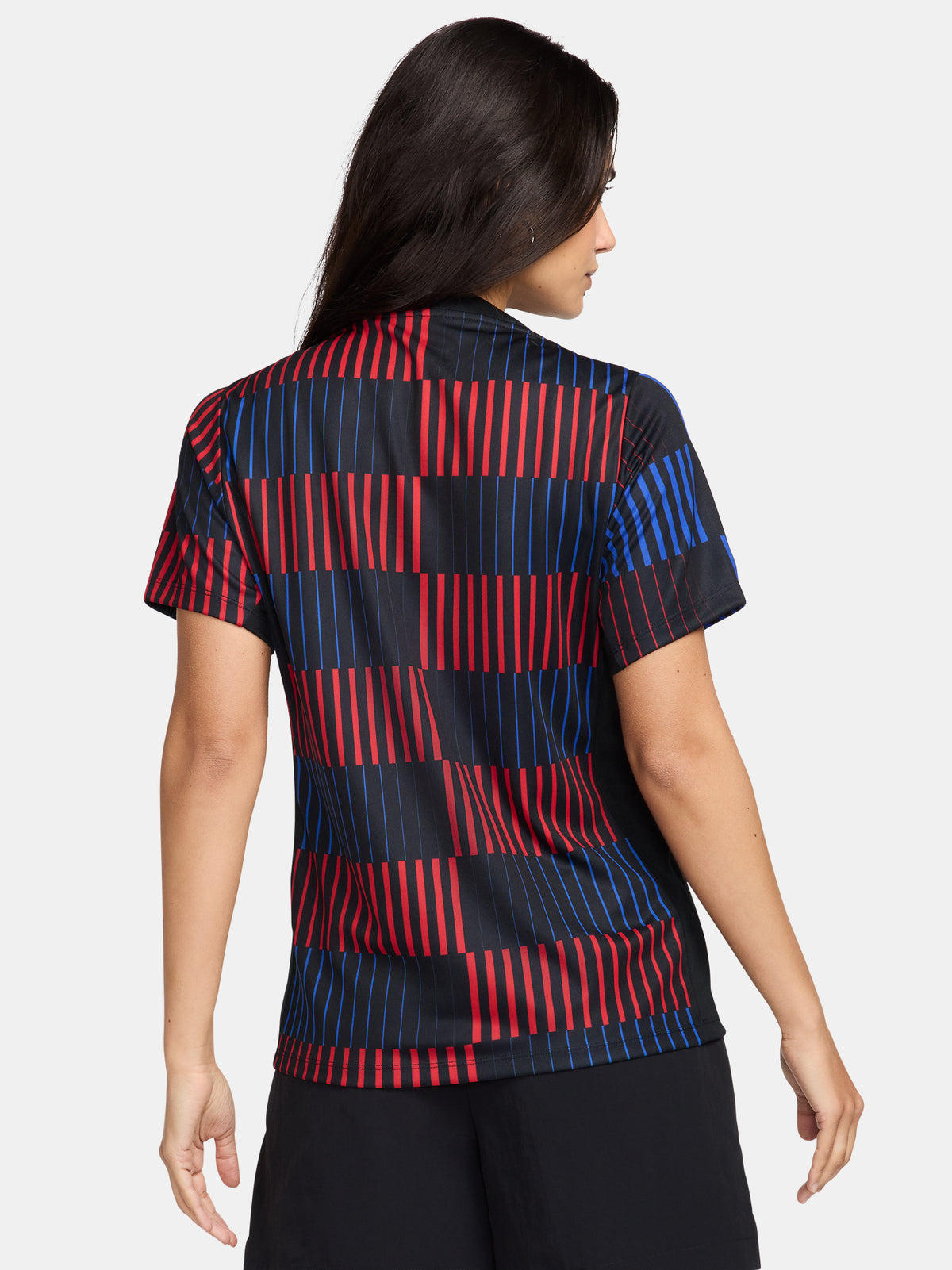 FC Barcelona warm-up shirt featuring a black base with a striking vertical stripe pattern in alternating red and blue. The shirt displays the red Spotify logo in the center, along with the Nike swoosh and FC Barcelona crest, also in red.