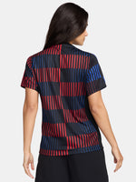 FC Barcelona warm-up shirt featuring a black base with a striking vertical stripe pattern in alternating red and blue. The shirt displays the red Spotify logo in the center, along with the Nike swoosh and FC Barcelona crest, also in red.
