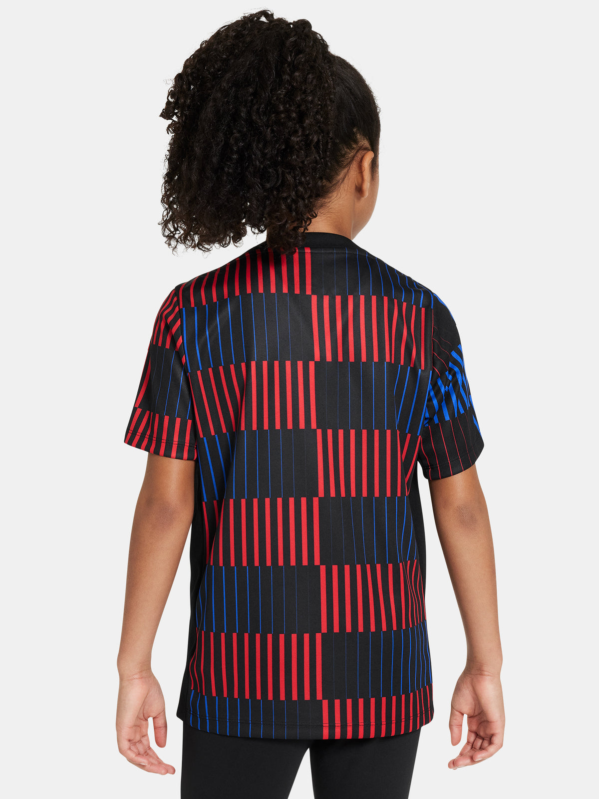FC Barcelona warm-up shirt featuring a black base with a striking vertical stripe pattern in alternating red and blue. The shirt displays the red Spotify logo in the center, along with the Nike swoosh and FC Barcelona crest, also in red.