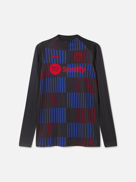 Long-sleeve FC Barcelona training top in black, featuring a dynamic vertical pattern of red and blue stripes on the front. Includes the red Nike logo, red Spotify sponsor logo, and the FC Barcelona crest in red.