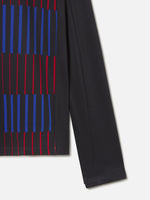 Long-sleeve FC Barcelona training top in black, featuring a dynamic vertical pattern of red and blue stripes on the front. Includes the red Nike logo, red Spotify sponsor logo, and the FC Barcelona crest in red.