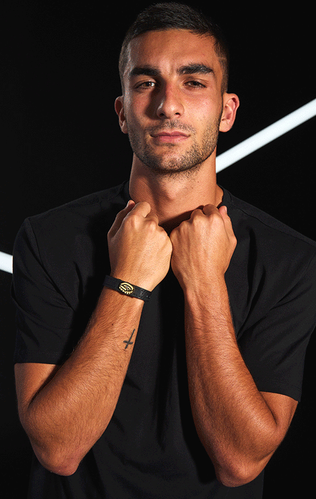 Black leather bracelet with gold eye-shaped clasp featuring a central diamond.